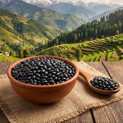 Bowl of black beans on a wooden surface with a scenic mountain landscape in the background