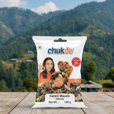 Chukde Garam Masala packet on a wooden surface with a mountainous landscape in the background