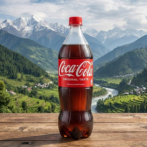 Coca-Cola bottle on a wooden surface with a scenic mountain landscape in the background