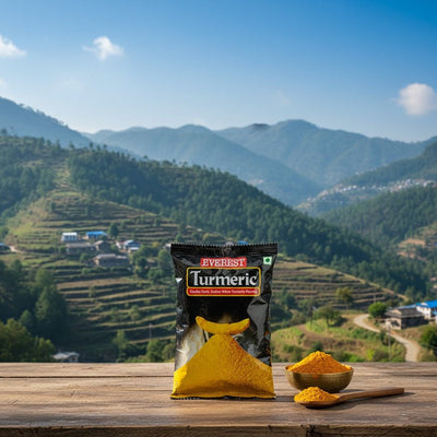 Everest Turmeric package with turmeric powder on a wooden surface with a mountainous landscape in the background