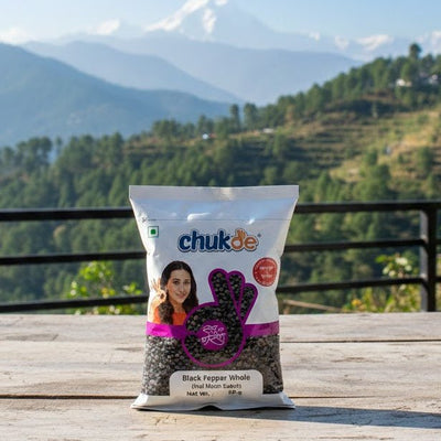 Package of chukas black pepper with a scenic mountain view in the background