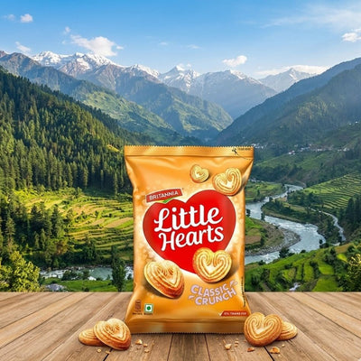 Bag of Britannia Little Hearts Classic Crunch cookies with a scenic mountain backdrop