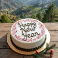 Happy New Year cake with a scenic mountain backdrop