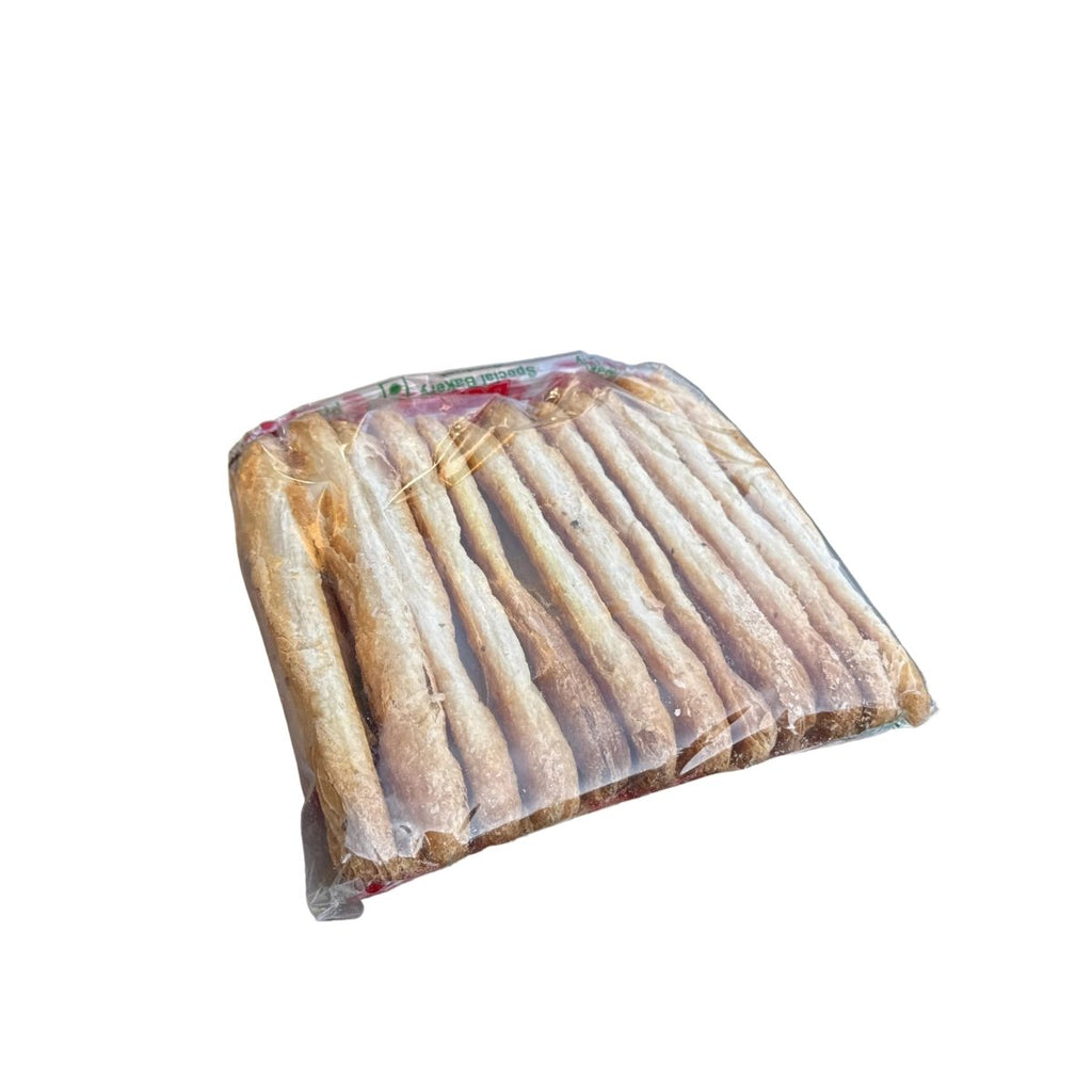 Packaged meat on a metal surface with a grill in the background