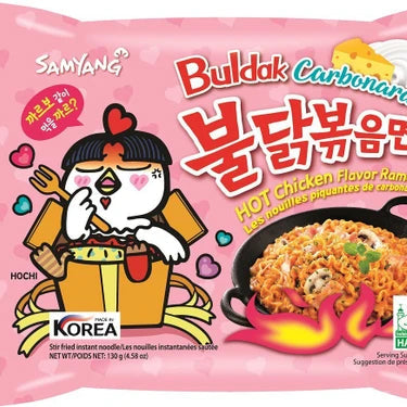 Samyang Buldak Carbonara hot chicken flavor ramen package with cartoon character on pink background