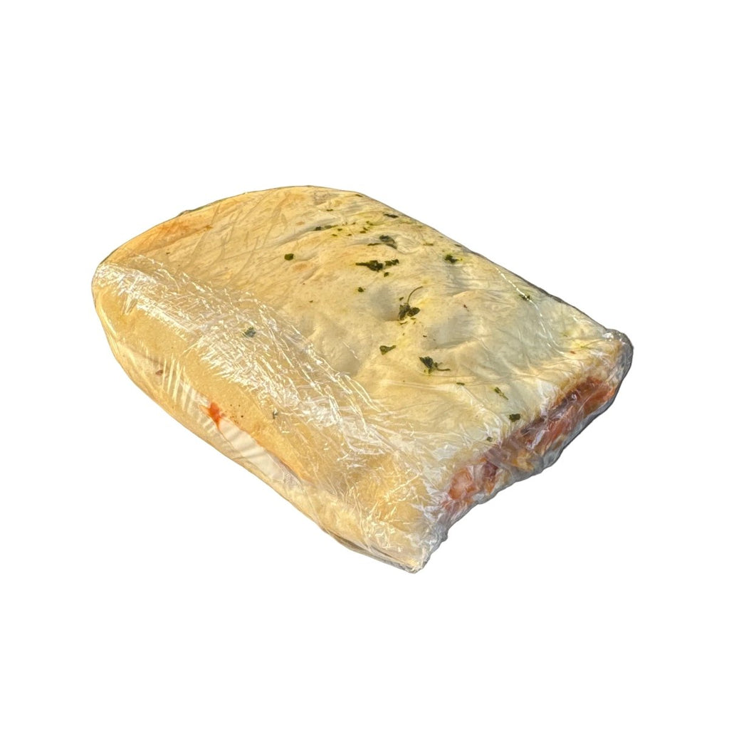 Cheese wedge on a metal surface with a grocery store shelf in the background