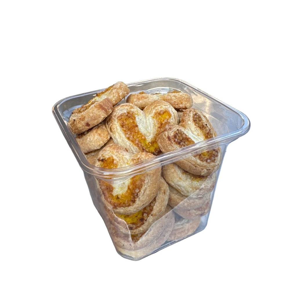 Container of pastries on a metal surface with a blurred background