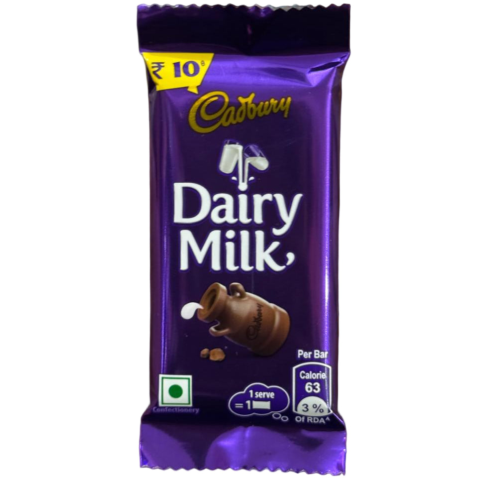 Cadbury Dairy Milk chocolate bar in a hand with a blurred background