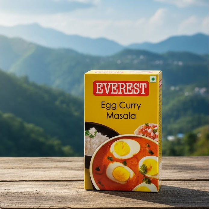 Box of Everest Egg Curry Masala on a wooden surface with a mountainous landscape in the background