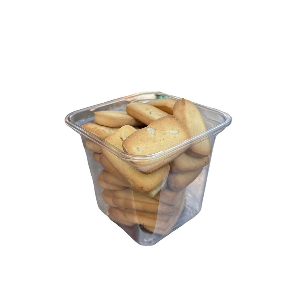 Container of cookies on a metal surface with a blurred background