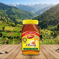 Dabur honey jar with a mountainous landscape in the background