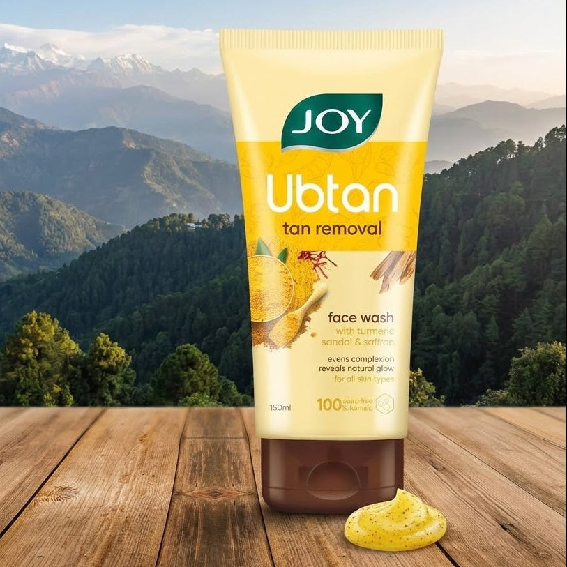 Tube of Joy Ubtan tan removal face wash with a mountainous landscape in the background