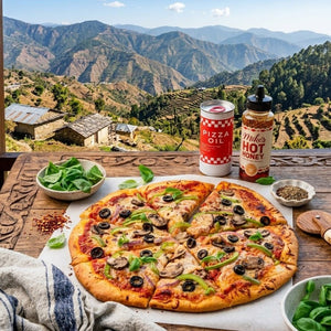 Pizza with toppings on a wooden table with a scenic mountain view in the background