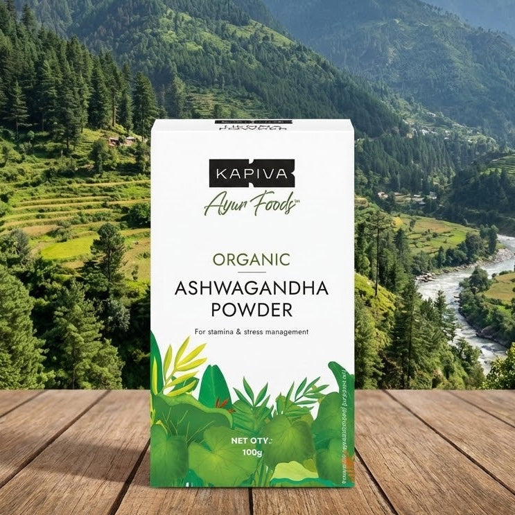 Kapiva Organic Ashwagandha Powder package on a wooden surface with a mountainous landscape in the background