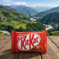 Kit Kat bar with Nestle logo against a scenic mountain backdrop