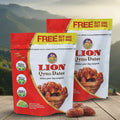 Two packages of Lion Qyno Dates with a scenic mountain background