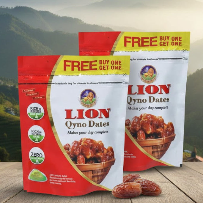 Two packages of Lion Qyno Dates with a scenic mountain background