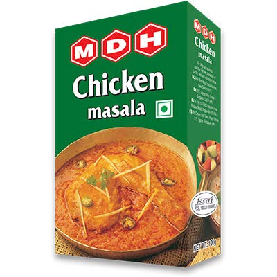 Box of MDH Chicken masala spice mix with a bowl of curry on a white background