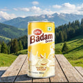 MTR Badam Drink can on a wooden table with a mountainous landscape in the background