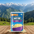 Act II popcorn package with a scenic mountain background
