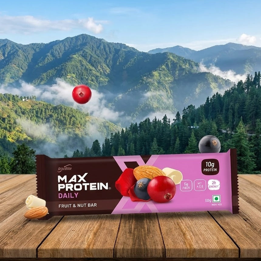 Max Protein Daily fruit and nut bar packaging with a mountainous landscape in the background