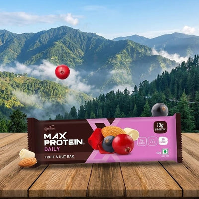 Max Protein Daily fruit and nut bar packaging with a mountainous landscape in the background