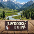 A chocolate bar with a mountainous landscape in the background
