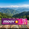 moov ointment box on a wooden surface with a mountainous landscape in the background