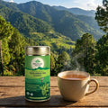 Steaming cup of tea and Organic India tulsi green tea canister with a scenic mountain background