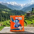 Surf Excel detergent packet with a scenic mountain background