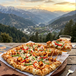 Pizza on a wooden board with a scenic mountain view in the background
