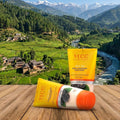 VLCC skincare products on a wooden surface with a scenic mountain landscape in the background