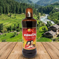 Bottle of Ashokarishta with a scenic mountain backdrop