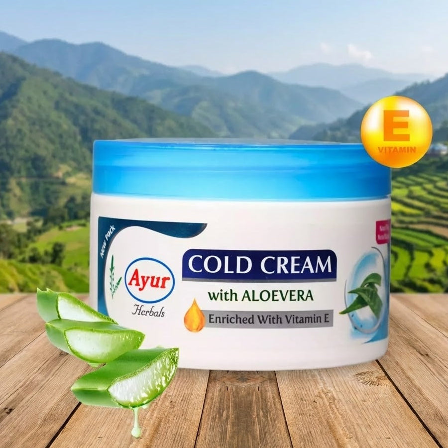 Jar of Ayur Cold Cream with Aloe Vera on a wooden surface with a mountainous background