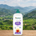 Himalaya Gentle Baby shampoo bottle on a wooden surface with a scenic mountain background
