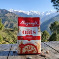 Bagrry's white oats package on a wooden surface with mountains in the background