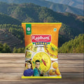 Rajdhani Besan packet on a wooden surface with a scenic mountain background
