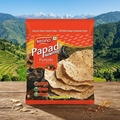 Packaged Punjabi Papad with a scenic mountain background