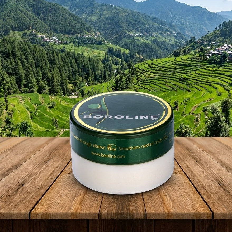 Boroline jar on a wooden surface with a scenic mountain landscape in the background