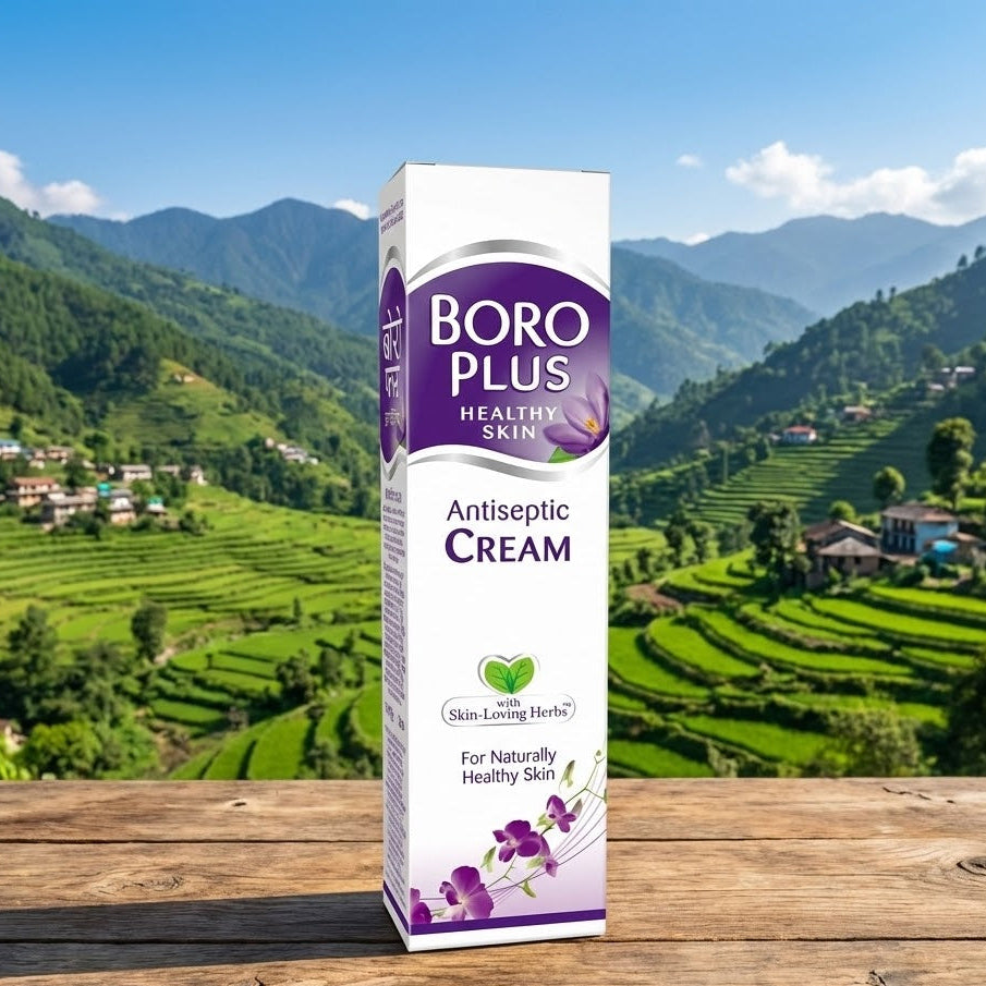 Boro Plus Antiseptic Cream box on a wooden surface with a scenic background of green hills and houses.