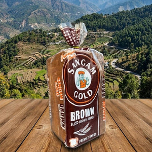 Packaged bread with 'San Cam Gold' branding on a wooden surface with a mountainous landscape in the background