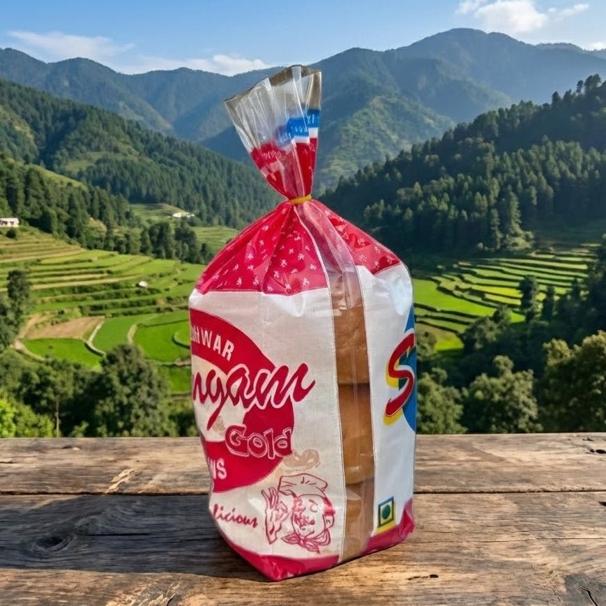 Bag of Suvam snacks on a wooden table with a scenic mountain background