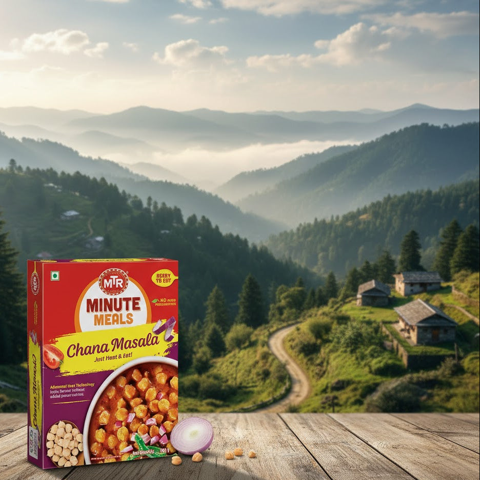 MTR Minute Meals Chana Masala box on a wooden surface with a scenic mountain landscape in the background