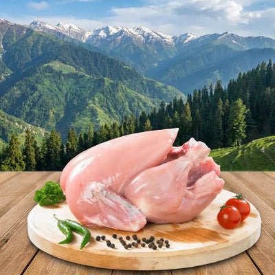 Raw chicken on a wooden cutting board with vegetables against a mountainous landscape