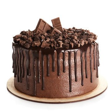 Chocolate cake with chocolate drizzle and pieces on a white background