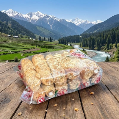 Packaged bread rolls on a wooden table with a scenic mountain landscape in the background