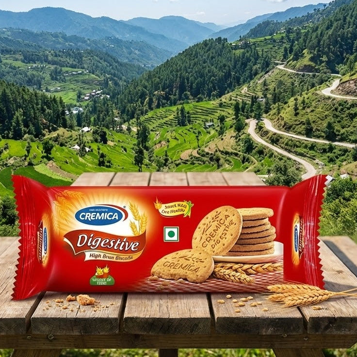 Cremica Digestive cookies package on a wooden table with a scenic mountain landscape in the background