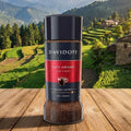 Davidoff Rich Aroma instant coffee jar on a wooden surface with a scenic mountain background