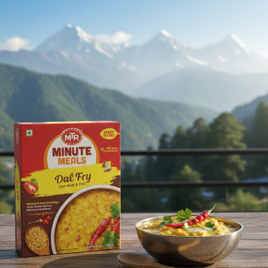 MTR Minute Meals Dal Fry package with a bowl of food on a wooden table against a mountainous background