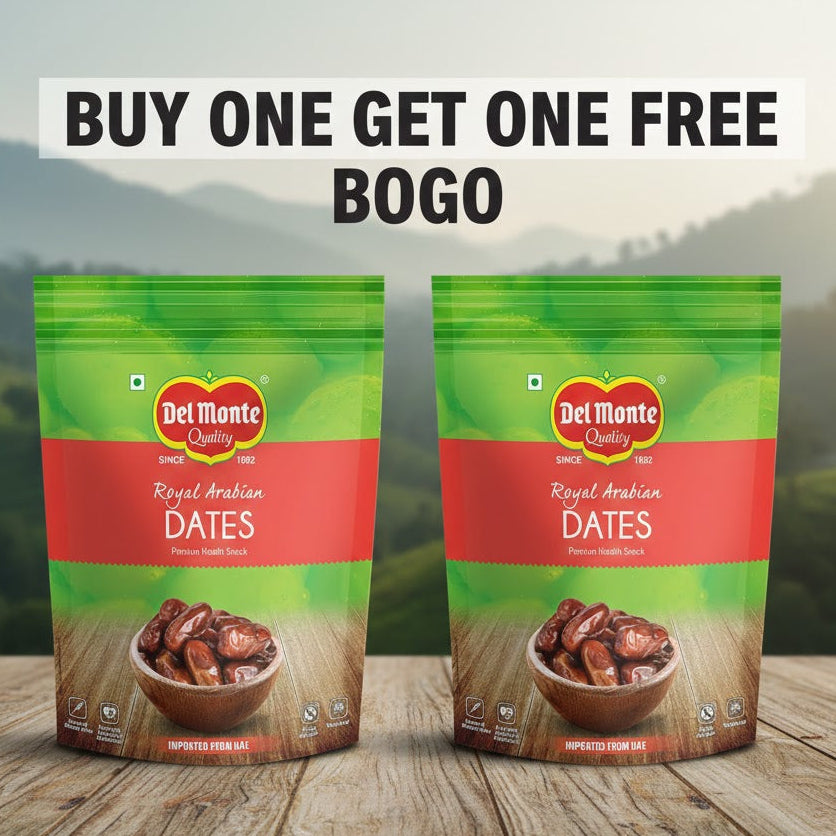Two packages of Del Monte Royal Arabian Dates on a wooden surface with a mountainous background.